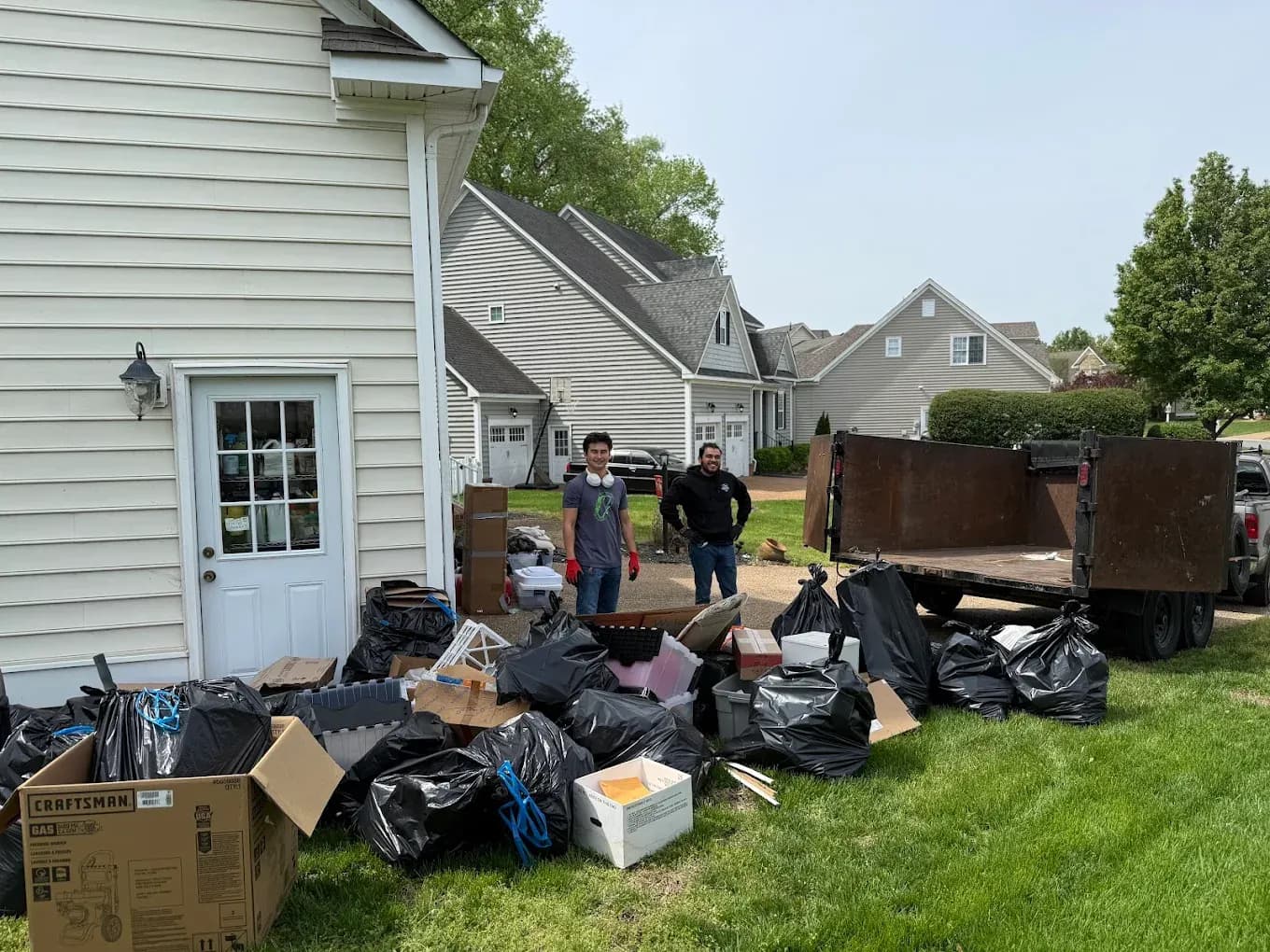 ProGrade Cleanups crew hauling boxes and old furniture during a garage cleanout in Norfolk, VA